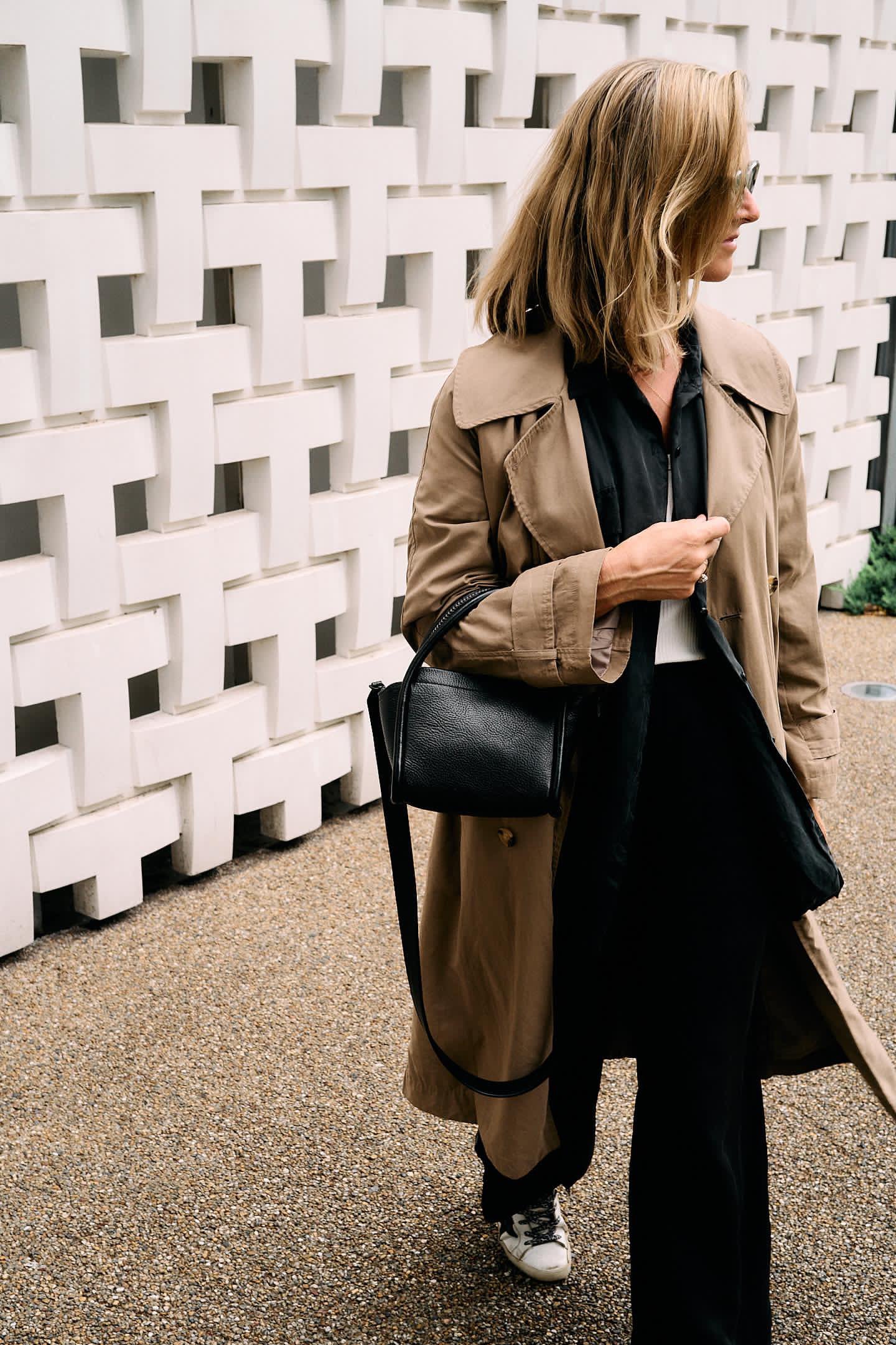 Richard Paige model holding a new release handbag in premium full-grain leather.